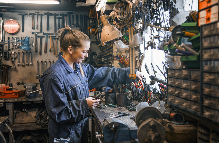 Female motor mechanic at work at the work shop. Photograph by Portra