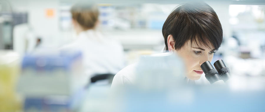 Female Scientist In A Busy Research Lab Photograph by Sturti