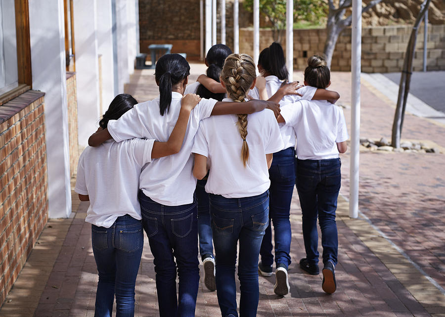 Female students walking together in schoolyard Photograph by Klaus Vedfelt