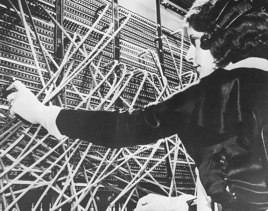 Female telephone switchboard operator connecting caller, close-up (B&W Photograph by Fpg