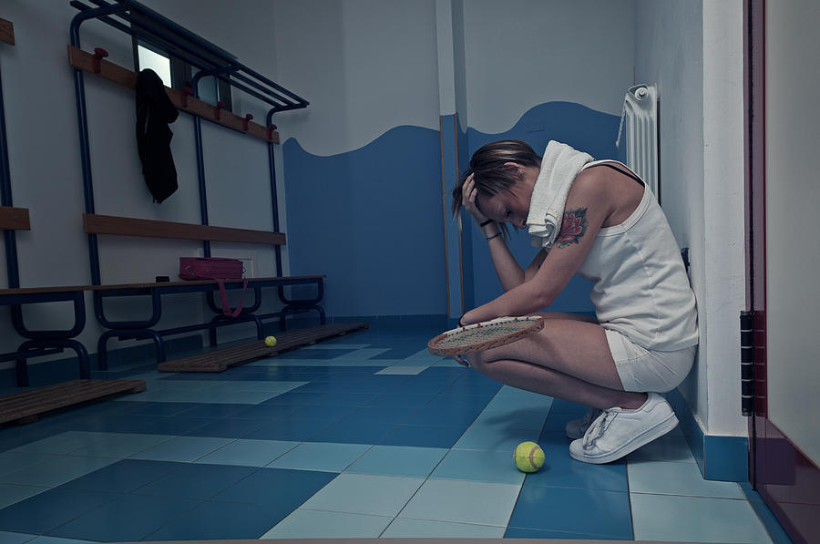 Female tennis player crouching in the locker room Photograph by Francesco Carta fotografo