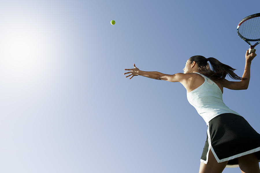 Female tennis player serving ball, low angle view Photograph by PhotoAlto/Sandro Di Carlo Darsa