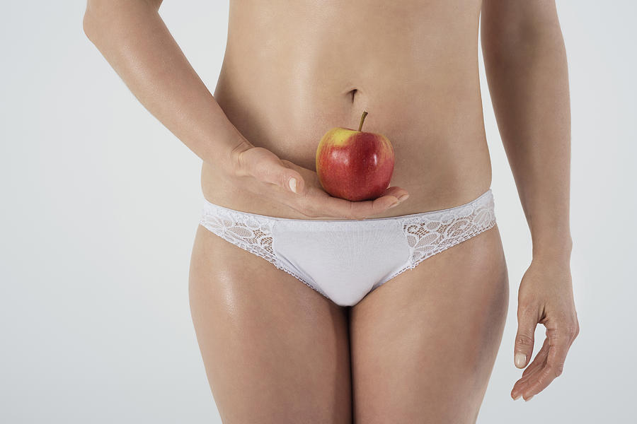 Female womb and an apple. Debica, Poland Photograph by Anna Bizon