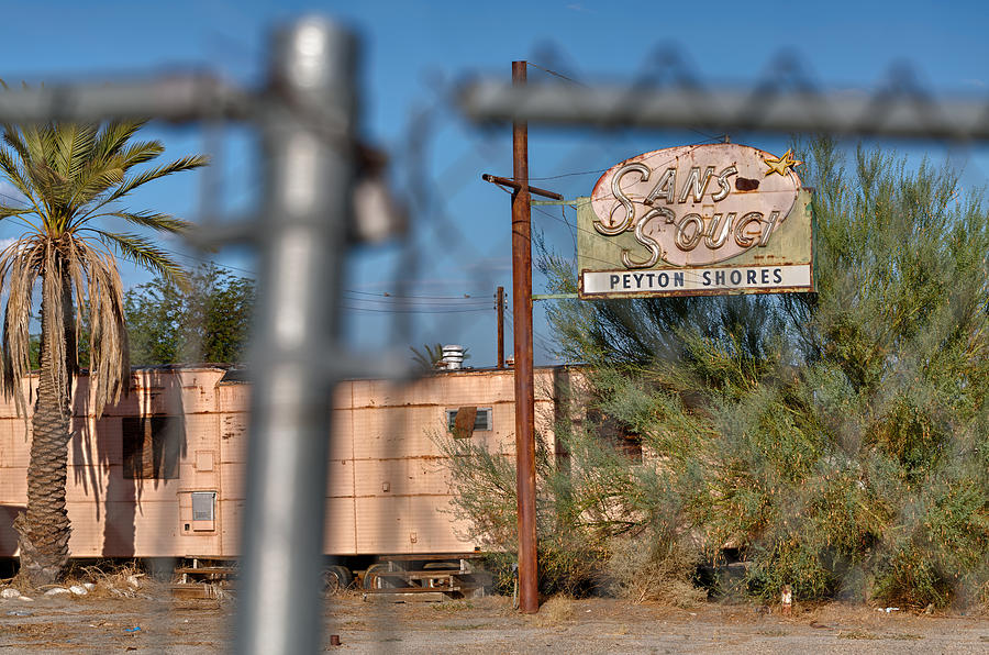 Sign Photograph - Fenced in  abandoned 1950s motel trailer by Scott Campbell