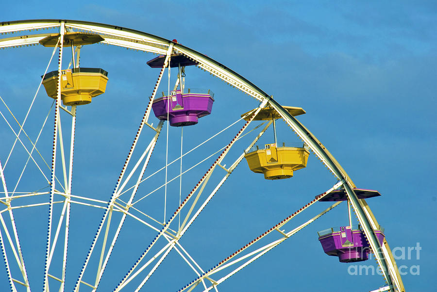 Ferris Wheel rotating upright wheel with passenger cars Photograph by David Zanzinger