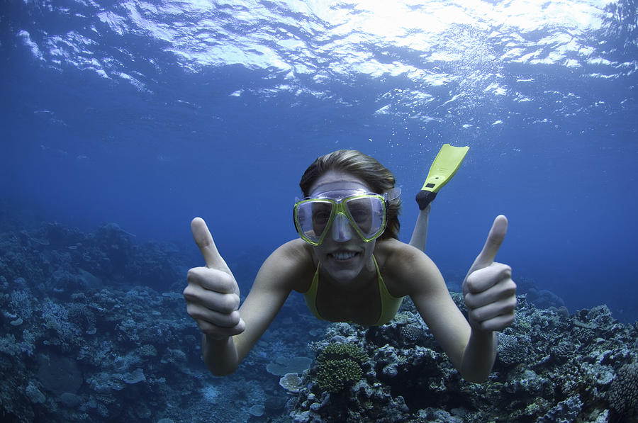 Fiji, young woman snorkeling, giving thumbs up, underwater view Photograph by Darryl Leniuk