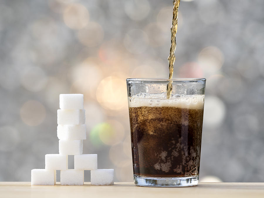 Filling a glass with cola and its equivalent in sugar cubes Photograph by Jose A. Bernat Bacete
