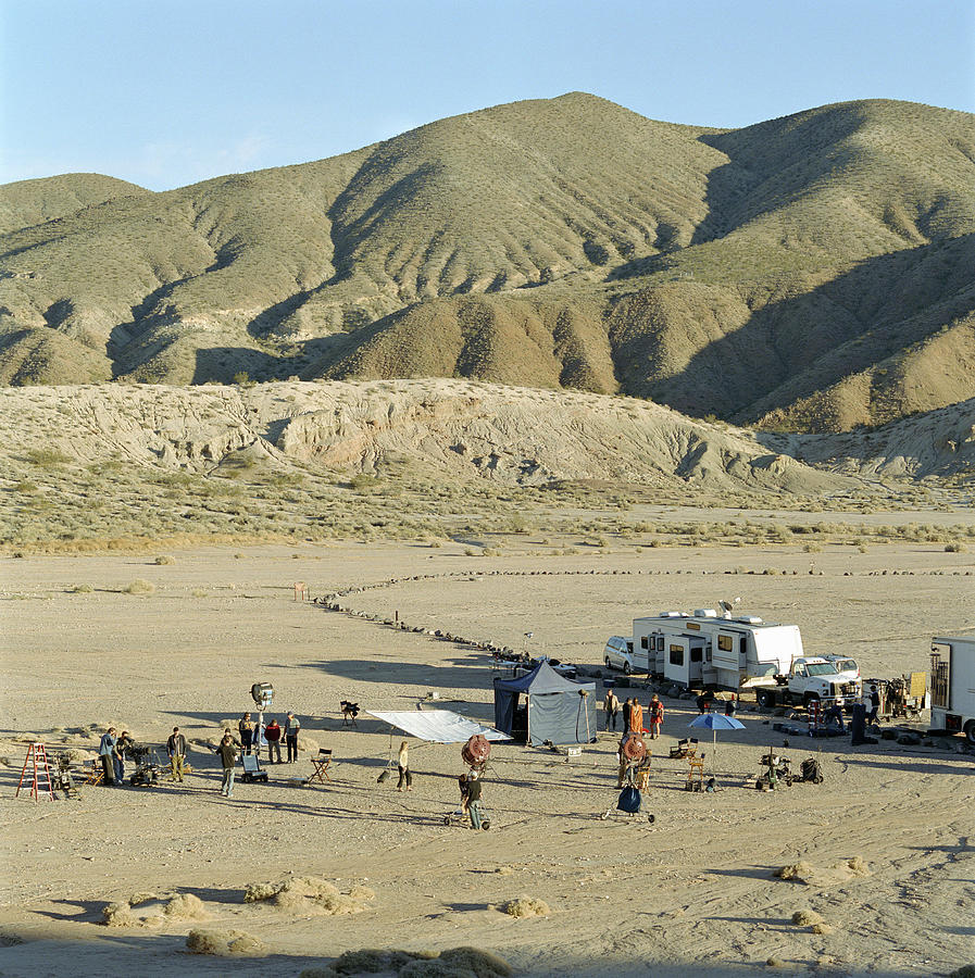 Film crew on location in desert, elevated view Photograph by Siri Stafford