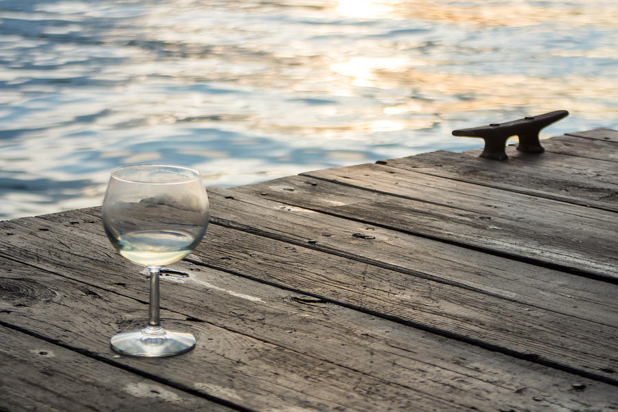 Finger lakes wine tasting - Wine Glass on the Dock Photograph by Photographic Arts And Design Studio