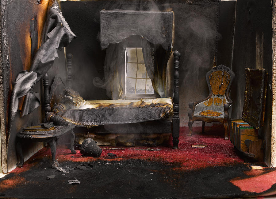 Fire in bedroom of model house, close-up Photograph by Jeffrey Hamilton
