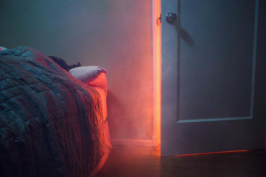 Fire Visible Through Bedroom Door Photograph by RyanJLane