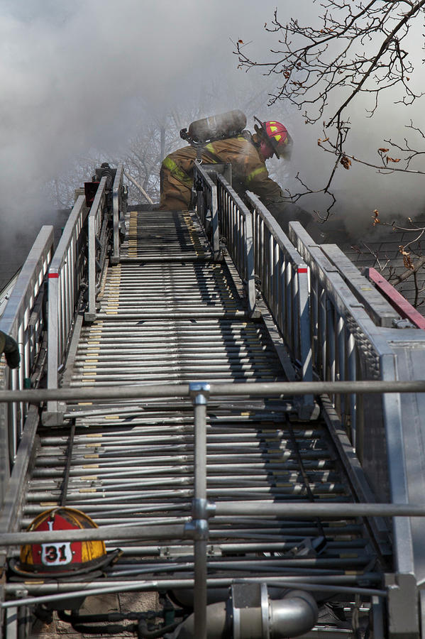 Firefighter On Telescopic Ladder Photograph by Jim West