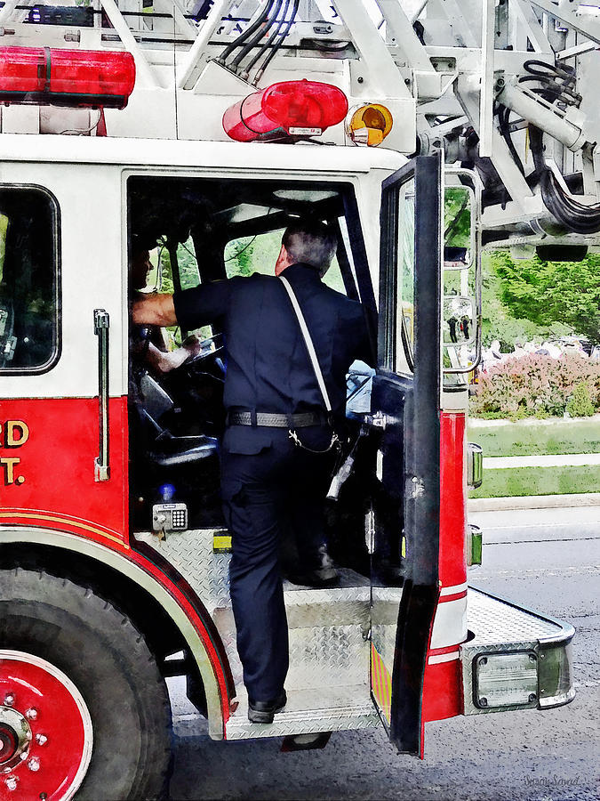 Fireman Climbing into Fire Truck Photograph by Susan Savad