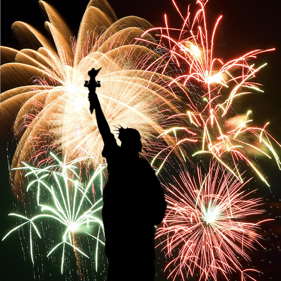 Fireworks behind Statue of Liberty silhouette Photograph by Thinkstock Images