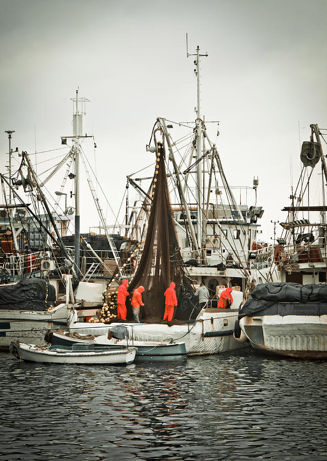 Fisherman crew fixing nets on fishing boat Photograph by Brch Photography