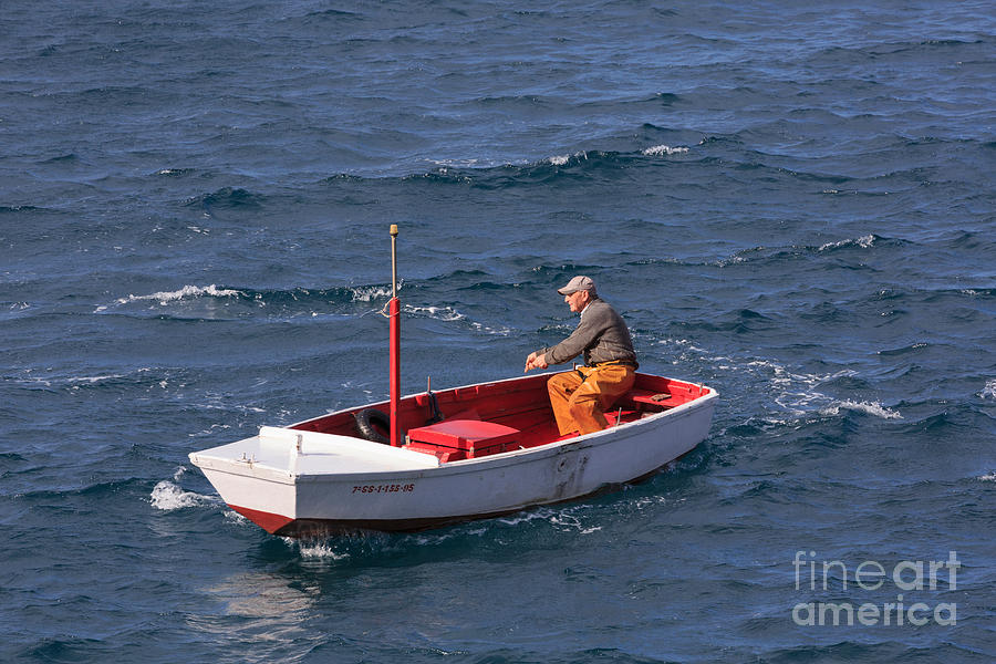 Fisherman in a small boat in Getaria Photograph by Louise Heusinkveld