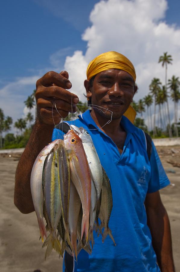Fish Photograph - Fisherman with catch in Indonesia by Science Photo Library