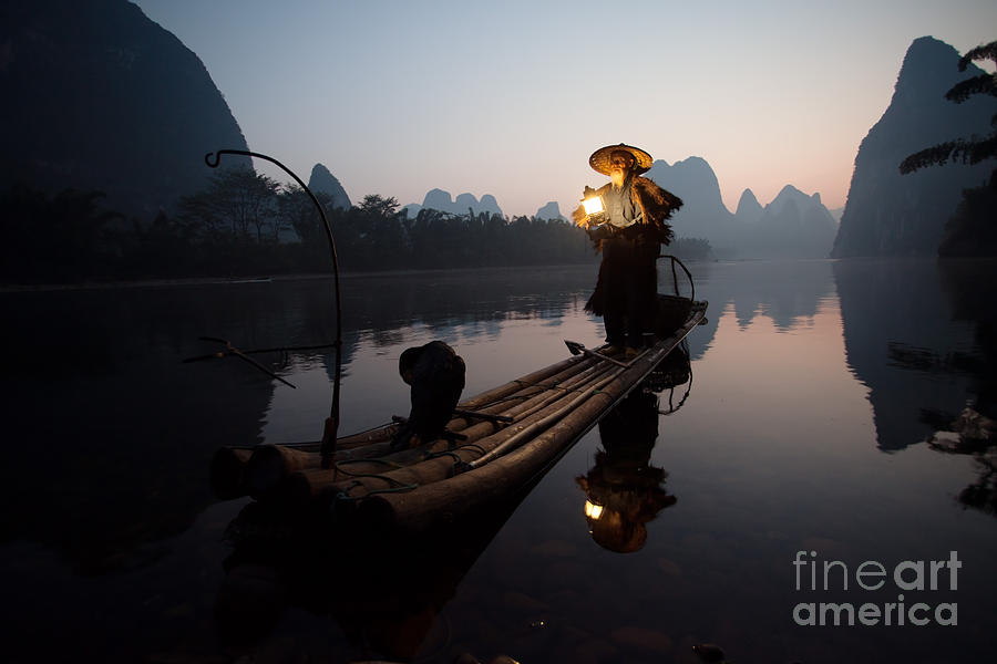Fisherman with cormorants on the Li river Yangshuo near Guilin China Photograph by Matteo Colombo