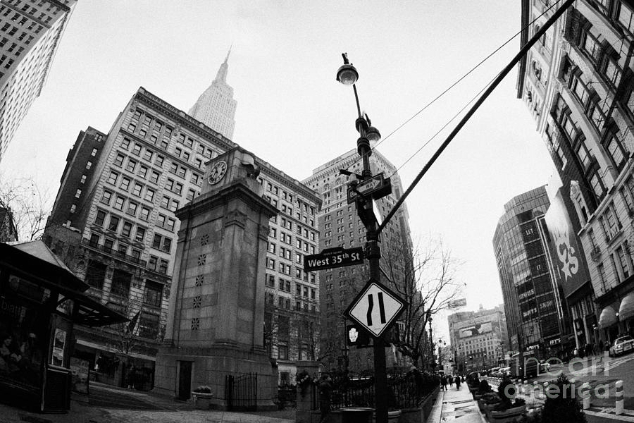 Winter Photograph - fisheye shot of Herald Square Macys and Broadway from 35th Street in the rain and empire state build by Joe Fox