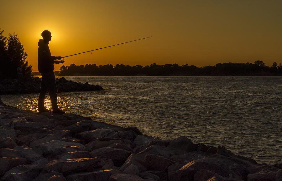 Fishing at sunset Photograph by David Kay