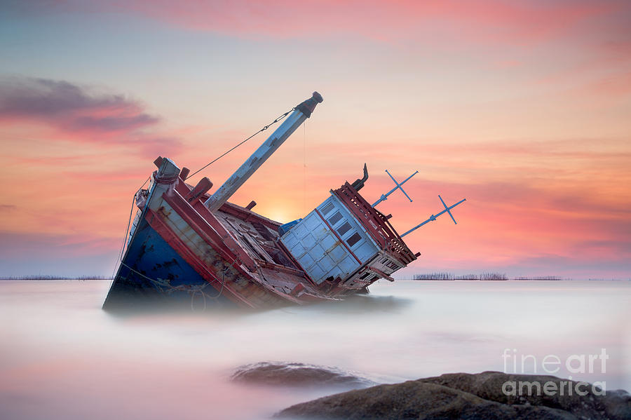 Sunset Photograph - Fishing boat beached by Anek Suwannaphoom