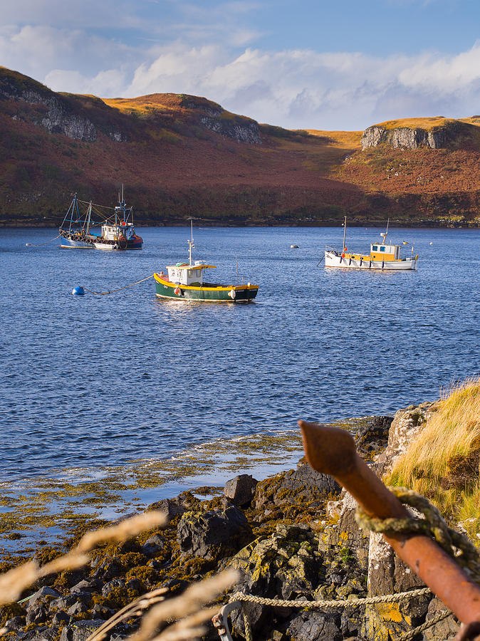 Fishing boats at anchor in a quiet bay on the Isle of Skye in Sc Photograph by Mark Llewellyn