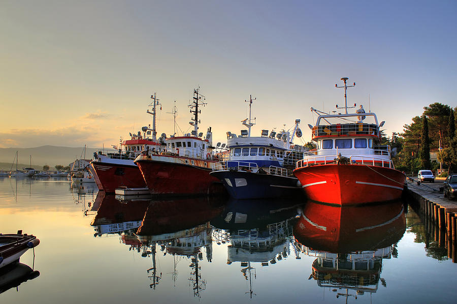 Fishing boats on early morning on calm sea Photograph by Brch Photography