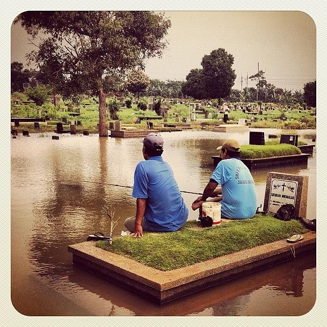 Disaster Photograph - Fishing In The Flooded Cemetery by Dani Daniar