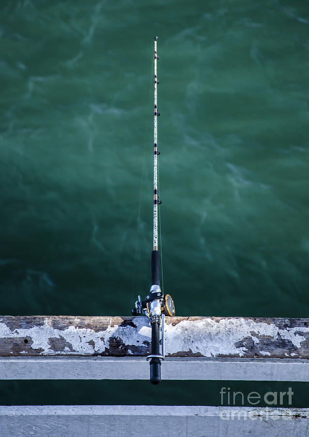 Relaxation Photograph - Fishing Rod And Reel Over Emerald Waters At The Pier by Jerry Cowart