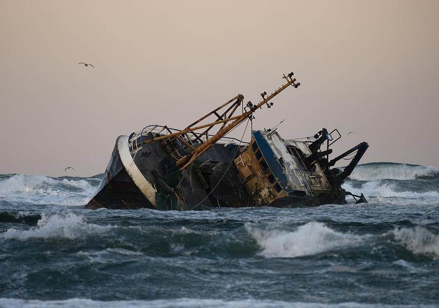 Fishing vessel boat aground on sea Photograph by Gannet77