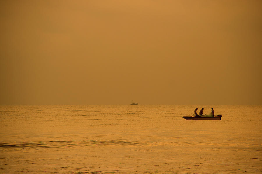 Fishreman Catching Fish At Payyambalam Photograph by Raja Singh - Bling Photography