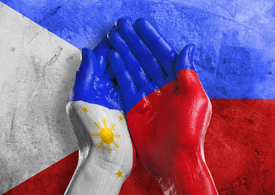 Flag of Philippines painted on two hands Photograph by Paper Boat London