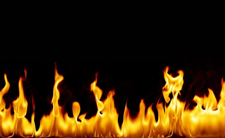 Flames against black background Photograph by Peter Dazeley