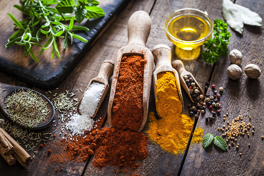 Flavoring: Spices and herbs on rustic wooden table Photograph by Fcafotodigital