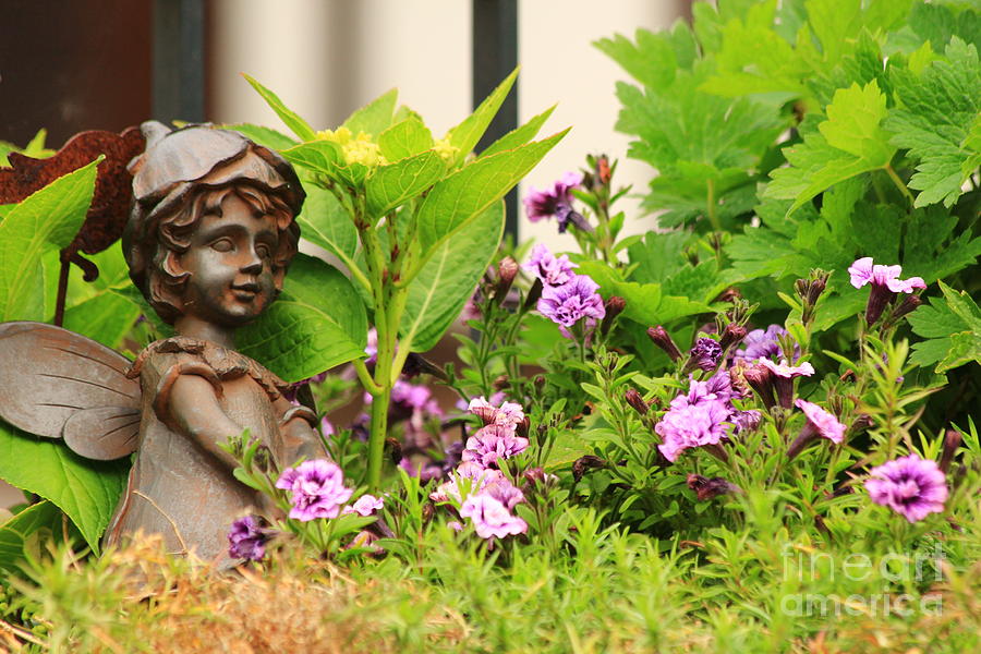 Flower-bed mit an angel statue Photograph by Amanda Mohler