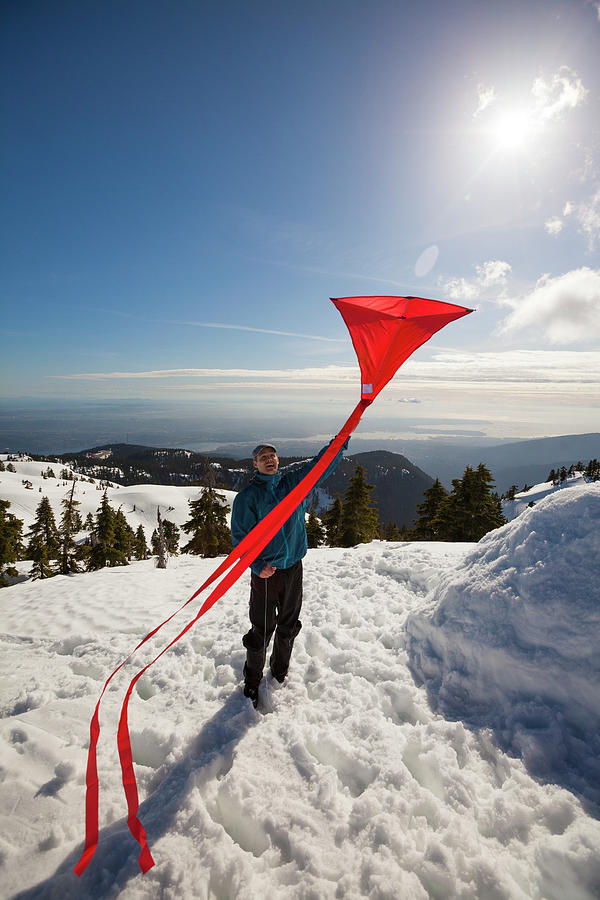 Nature Photograph - Flying A Kite On A Snowy Mountain by Christopher Kimmel