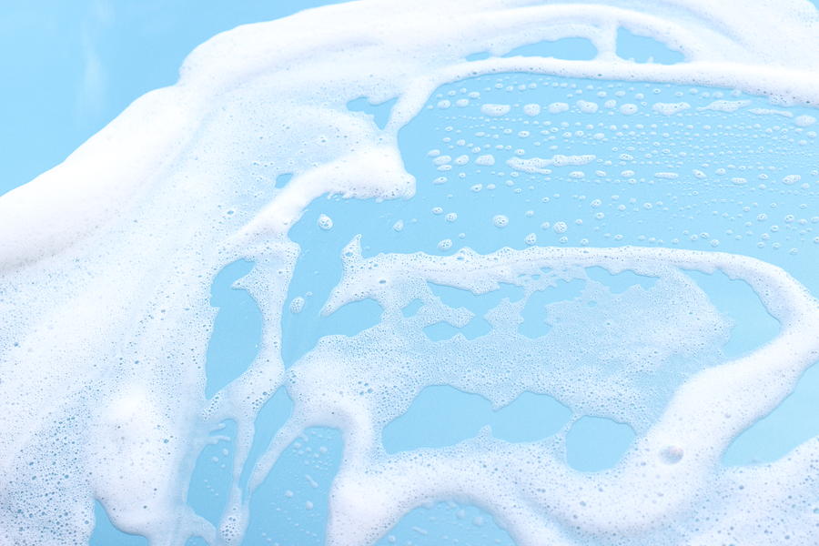 Foam on blue motorhood background Photograph by Deepblue4you