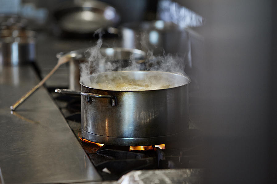 Font cooking on stow in kitchen at restaurant Photograph by Klaus Vedfelt