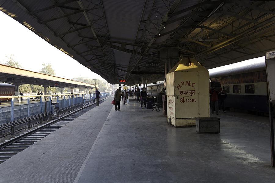 Food and drink stalls and passengers on a platform in the Jodhpur train station Photograph by Ashish Agarwal