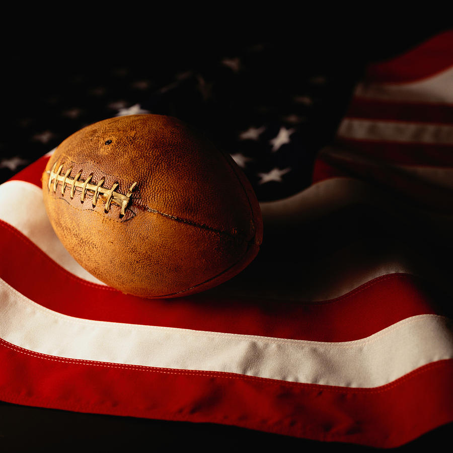 Football on American Flag Photograph by Photodisc