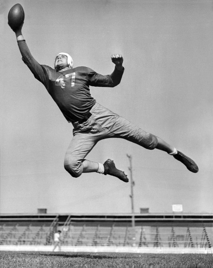 Football Player Catching Pass Photograph by Underwood Archives