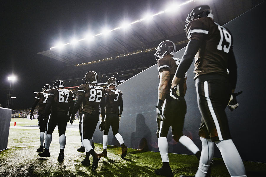 Football team walking out of stadium tunnel Photograph by Thomas Barwick