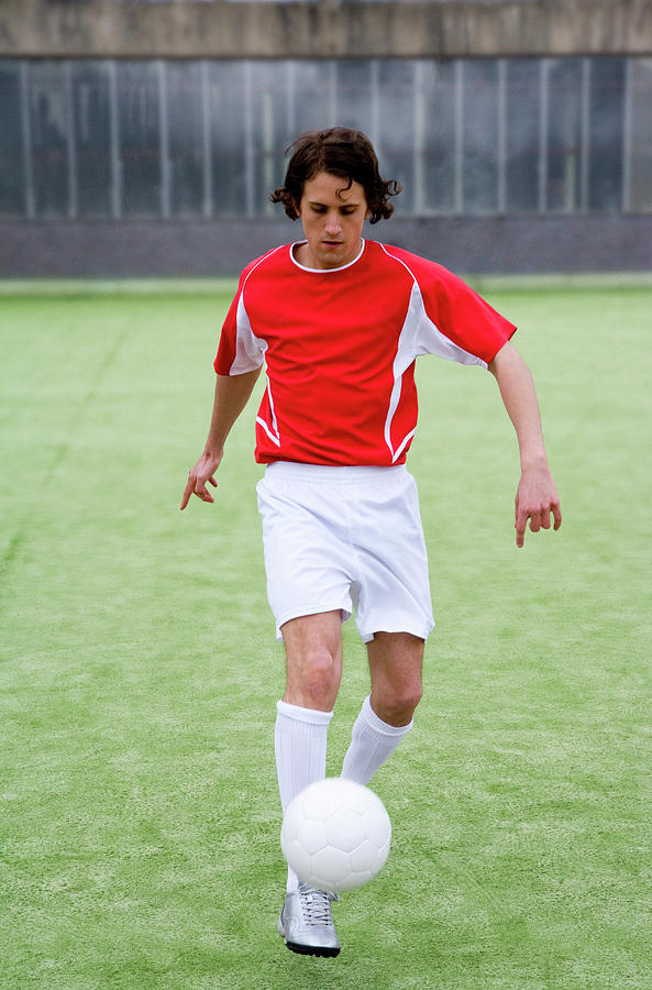 Footballer Photograph by Gustoimages/science Photo Library