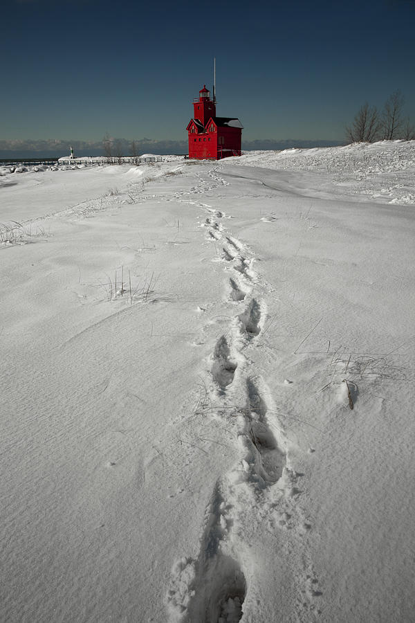 Footprints leading from the Lighthouse Big Red during Winter Photograph by Randall Nyhof