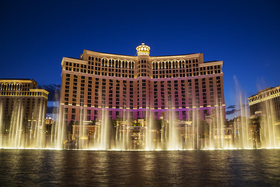 Fountains of Bellagio at sunset: hotel casino in Las Vegas Photograph by Alina555