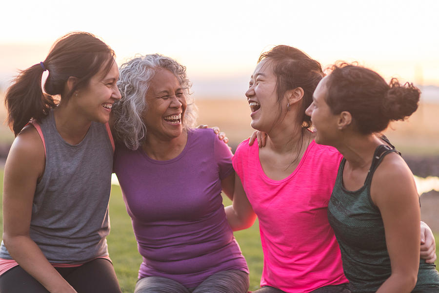 Four ethnic women laughing together after an outdoor workout Photograph by FatCamera