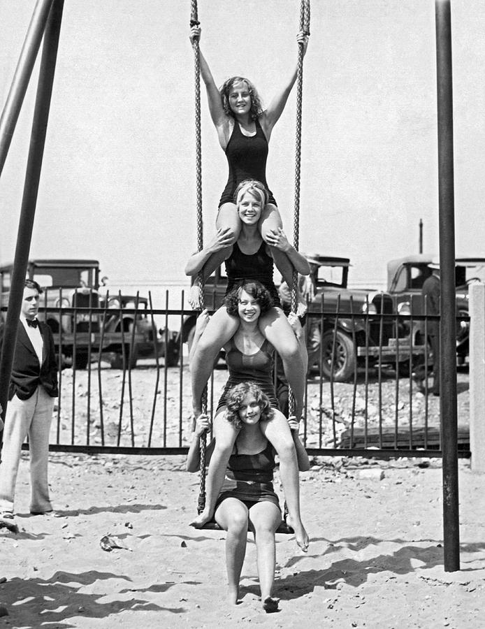 Four Girls On A Swing Set Photograph by Underwood Archives