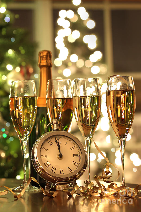 Four glasses of champagne ready for the New Year Photograph by Sandra Cunningham