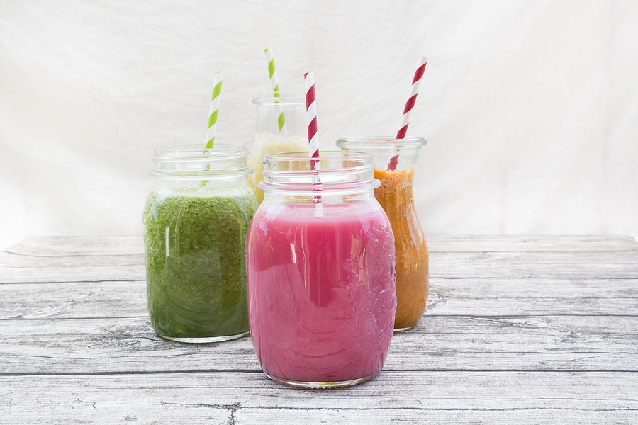 Four glasses of different smoothies Photograph by Westend61