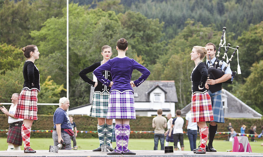 Four highland dancers doing Sword Dance with Piper Photograph by SoopySue